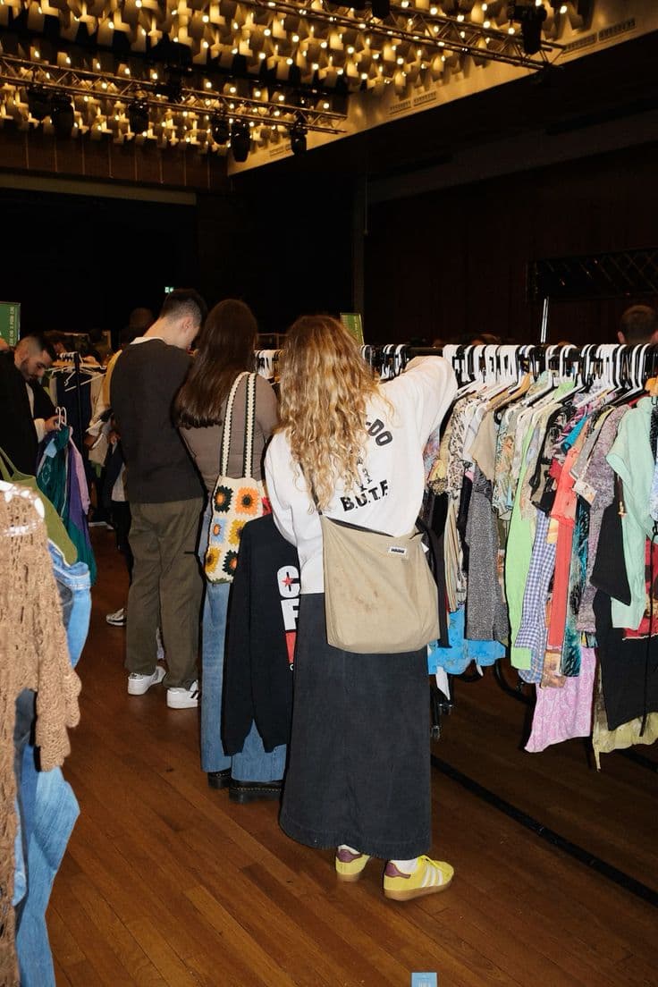 People browsing rails at a community clothing swap